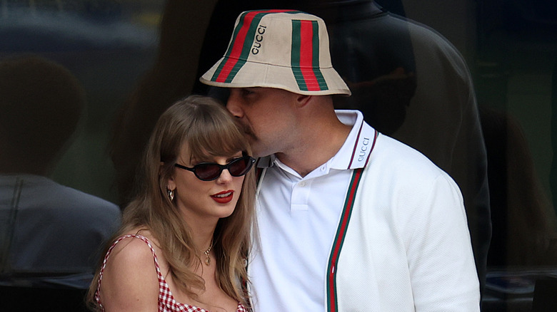 Travis Kelce kissing Taylor Swift on the head