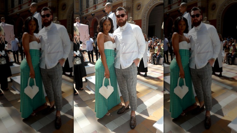 Travis Kelce and Kayla Nicole posing at Paris Fashion Week