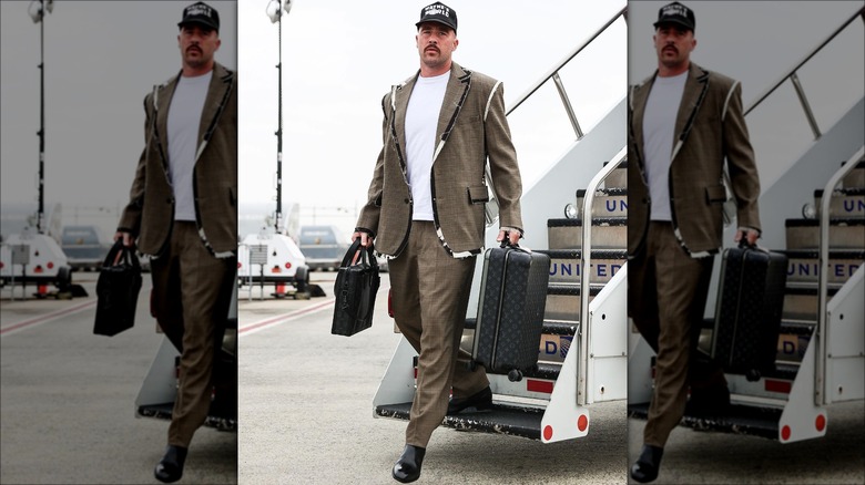 Travis Kelce walking off an airplane