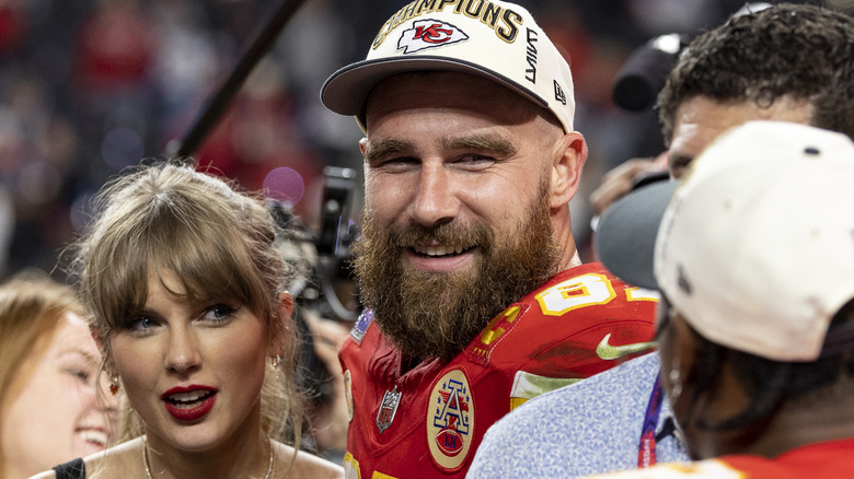 Taylor Swift and Travis Kelce on the field after the Super Bowl