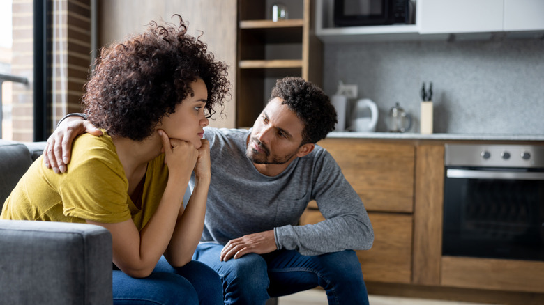 Couple talking together on couch