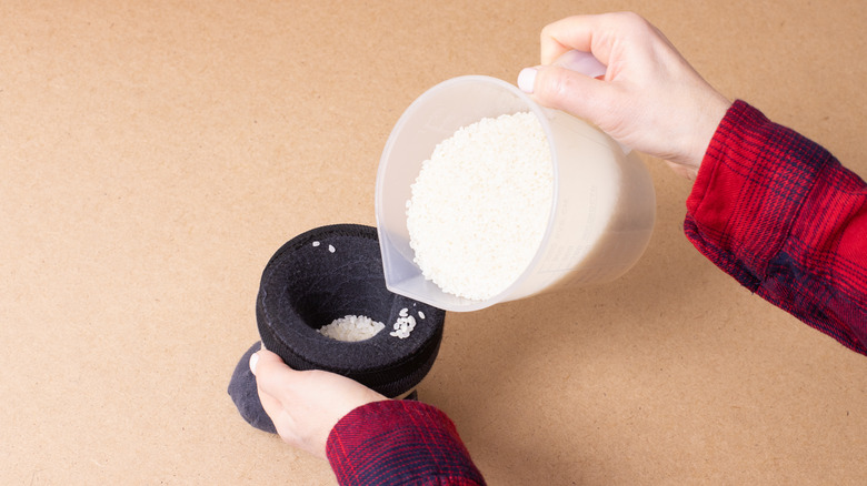 Filling a sock with rice