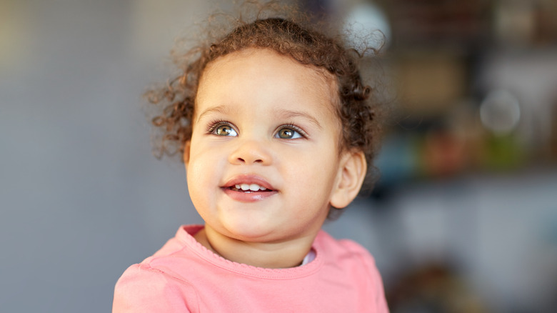 little girl with beautiful eyes and smile and curly hair