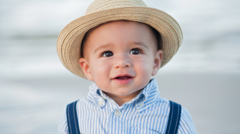 Little boy with rimmed hat suspender and button up