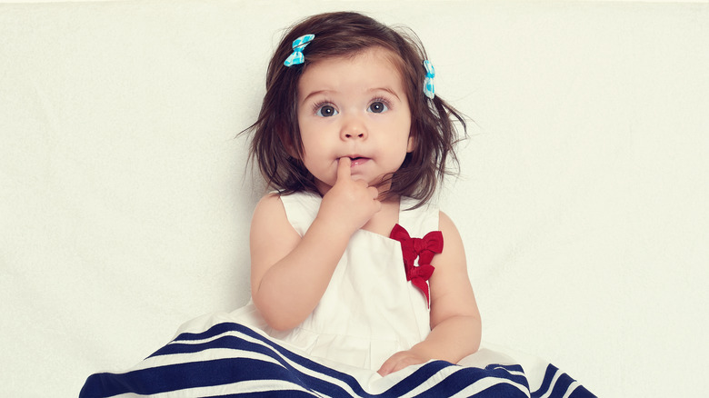 adorable little girl with bows and in a sailor dress