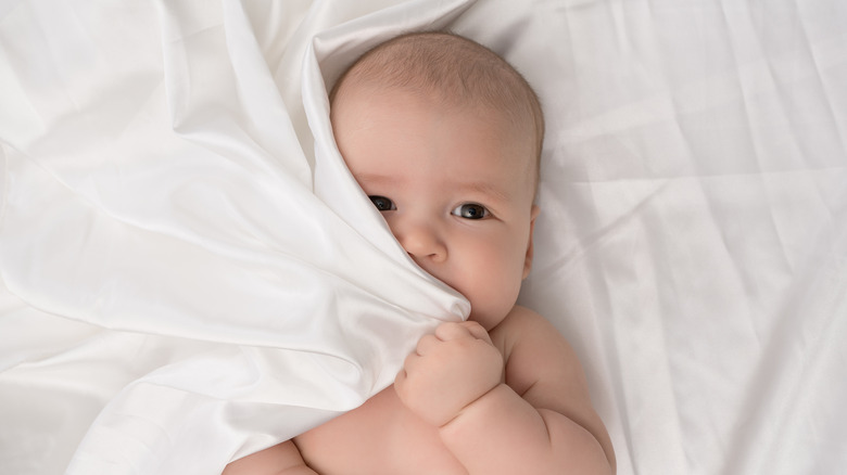 baby hiding in the sheets