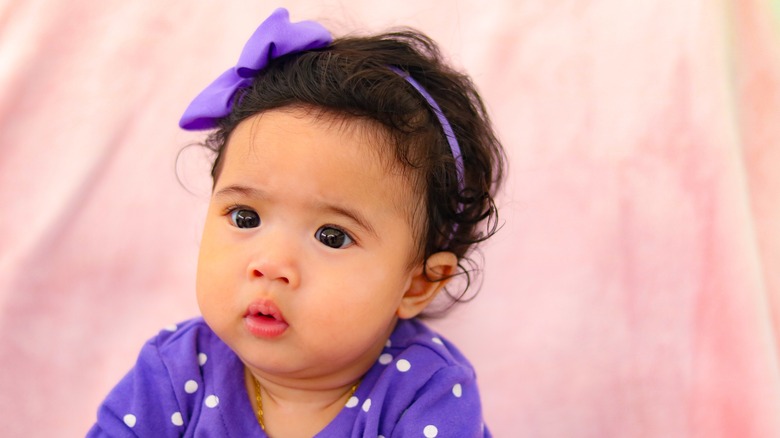 Little girl with big purple hair bow