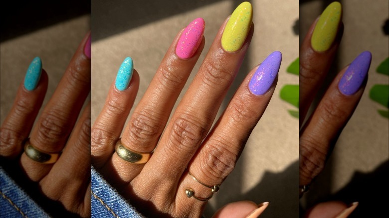 Hand with multicolored nails