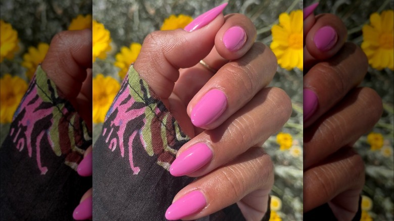 Hand with bright pink nails