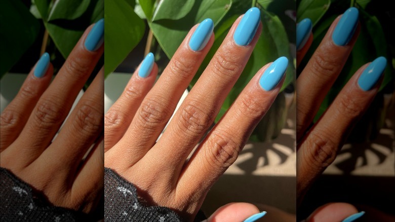 Hand with aqua turquoise nails 