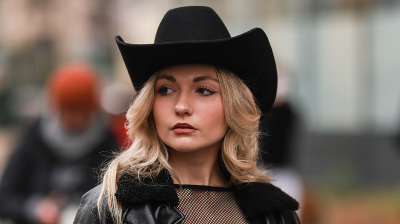 Girl with black cowboy hat