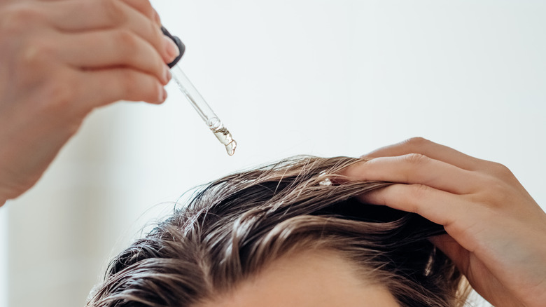 Woman using hair serum