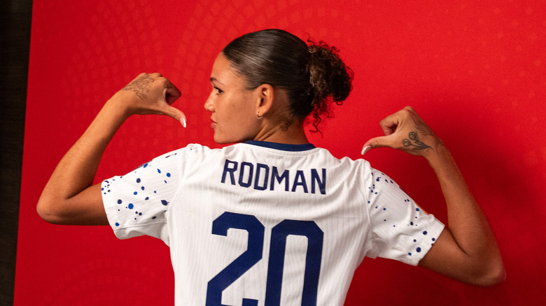 Trinity Rodman pointing at her soccer jersey