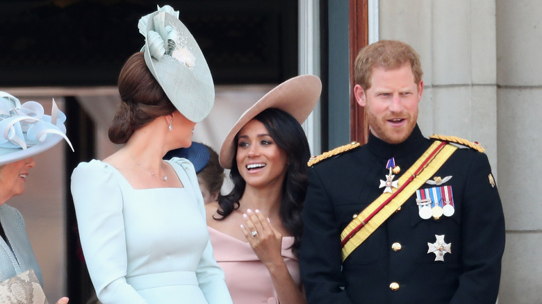 Kate Middleton talking to Meghan Markle