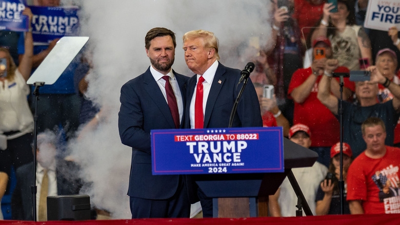 Donald Trump and JD Vance shaking hands on stage