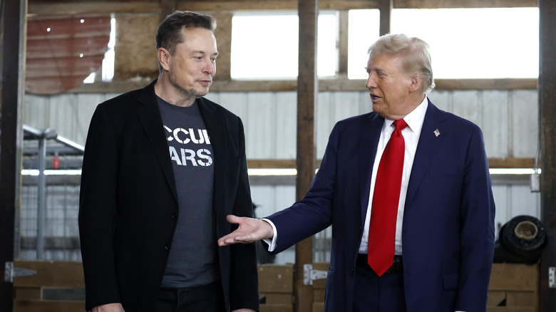 Donald Trump holds out his hand to Elon Musk