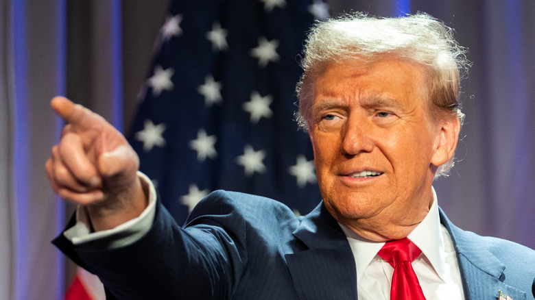 Donald Trump pointing while sporting a bright orange glow