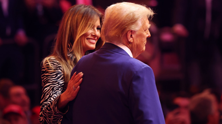 Melania patting Donald Trump on the back