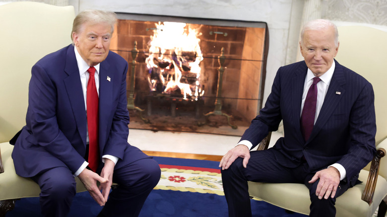 Donald Trump and Joe Biden seated in suits by roaring fireplace