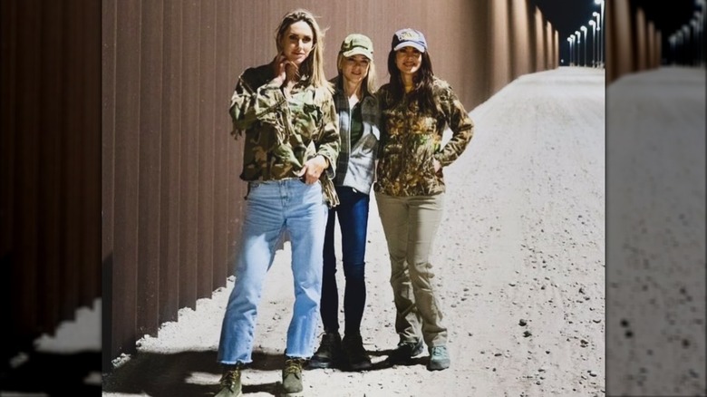 Lara Trump, Pam Bondi, and Morgan Ortagus posing in front of border wall