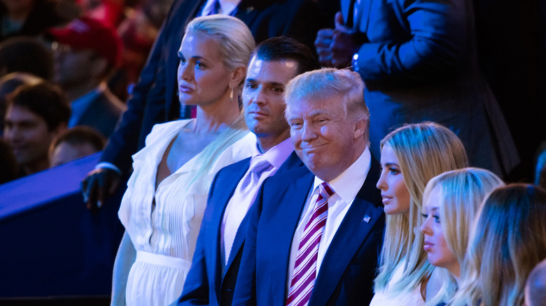 Donald Trump smiling while standing with his family