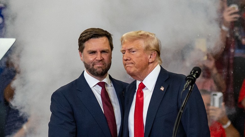 JD Vance and Donald Trump posing together in matching suits