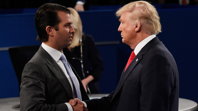 Donald Trump shakes hands with son Donald Trump Jr. in 2016.