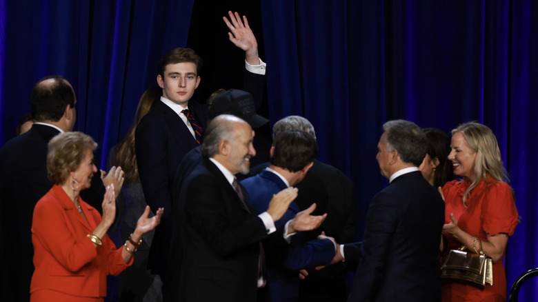 Barron Trump waving at the Palm Beach Convention Center in 2024