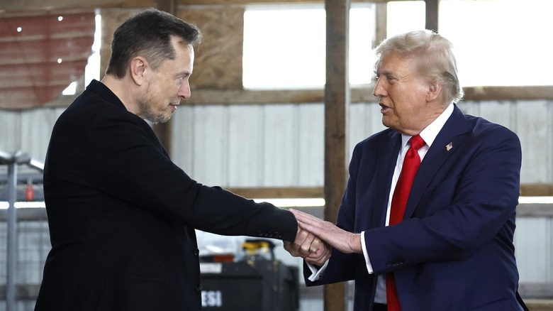 Donald Trump shaking both hands with Elon Musk