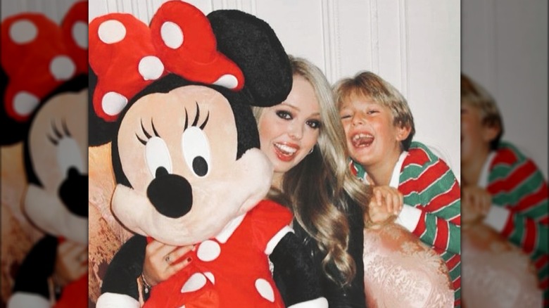 Tiffany Trump and Barron Trump posing with Minnie Mouse doll