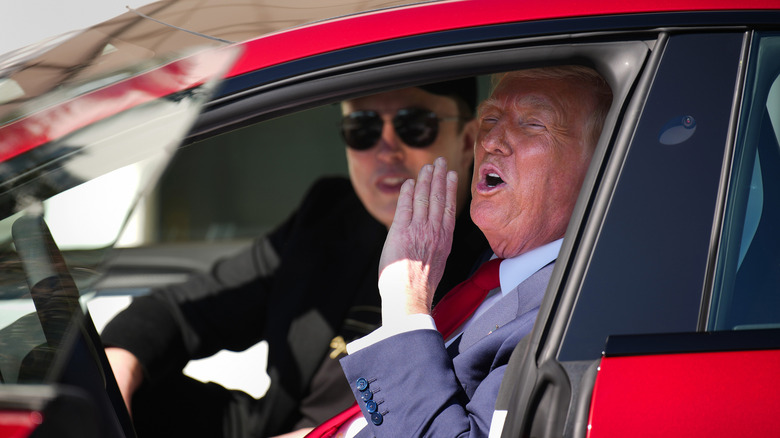 Donald Trump calling out from Tesla with Elon Musk inside