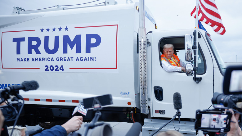 Donald Trump in Trump-labeled garbage truck