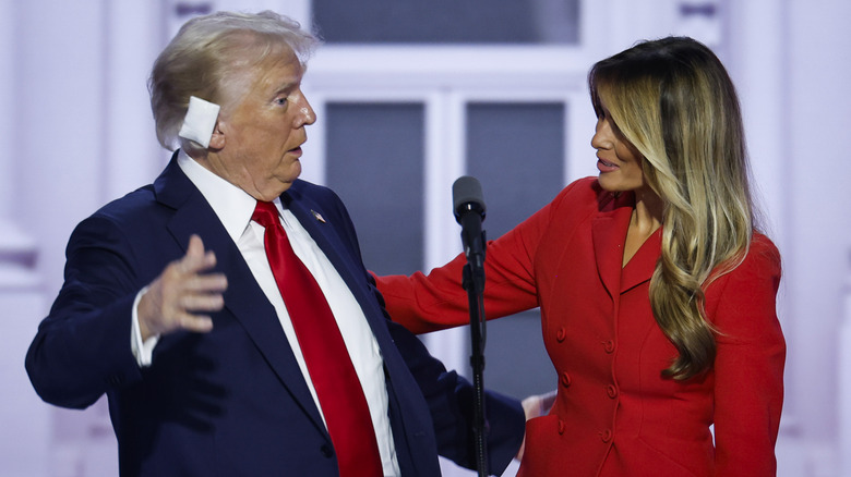 melania trump and donald trump onstage hug