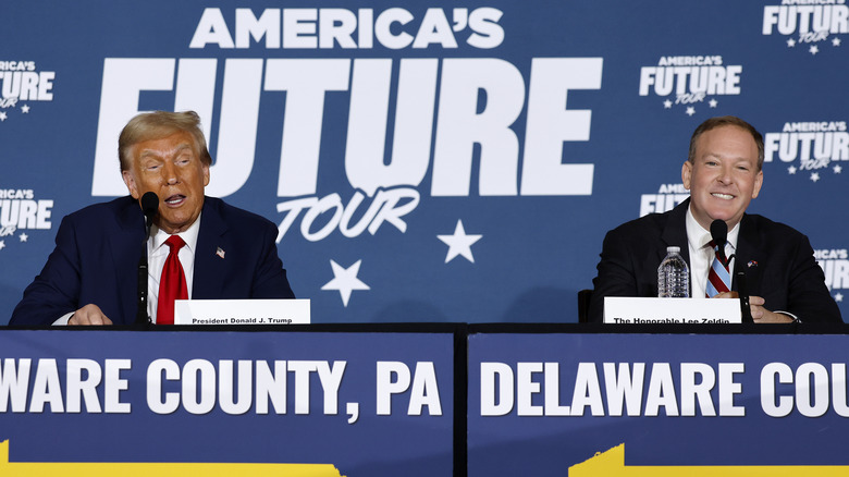 Donald Trump and Lee Zeldin sitting next to each other at a panel