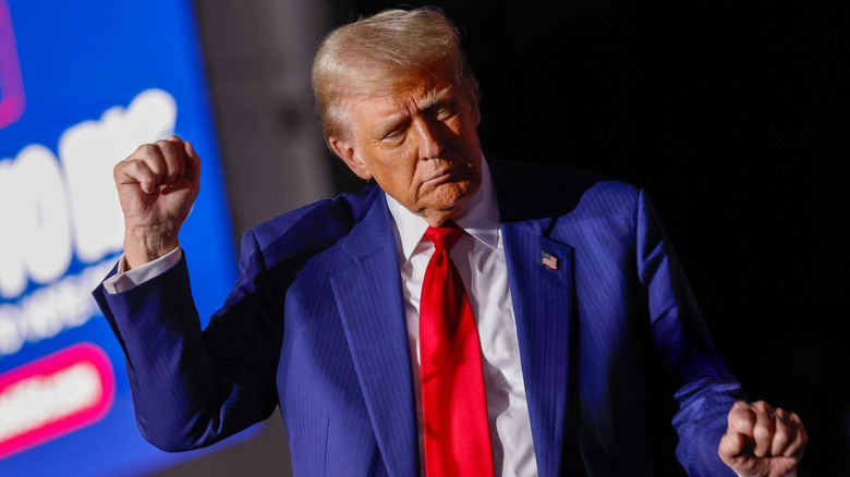 President-elect Donald Trump holding one fist in the air while dancing at the Suburban Collection Showplace