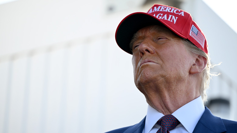 Donald Trump wearing a red MAGA hat