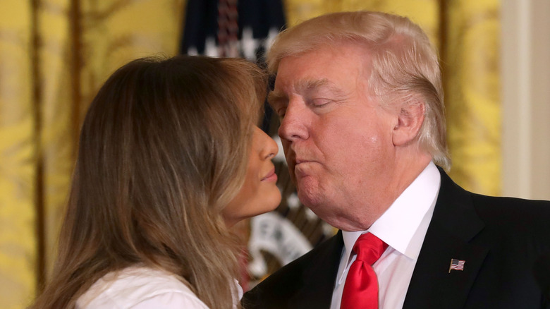 Donald Trump and Melania Trump going in for a kiss