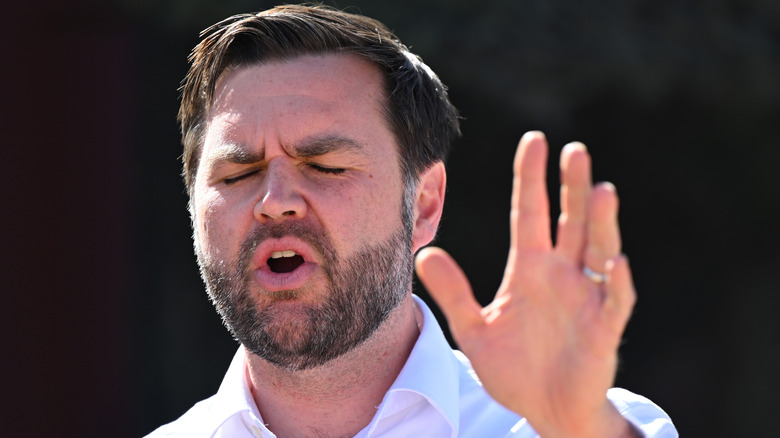 JD Vance speaking with a hand raised