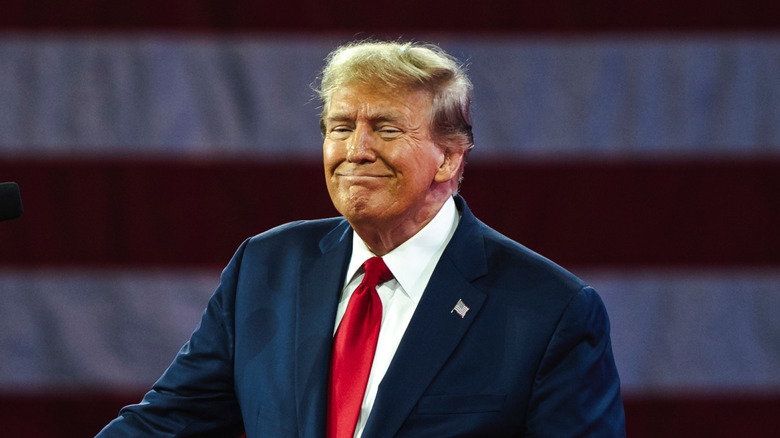 Donald Trump smiling at a podium