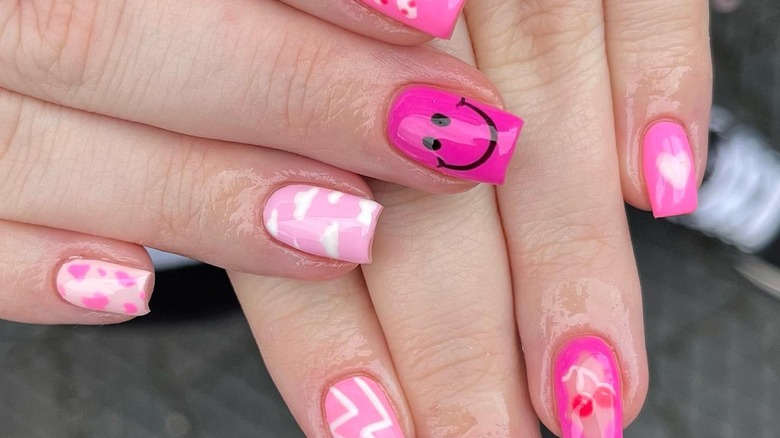 pink abstract smiley face nails