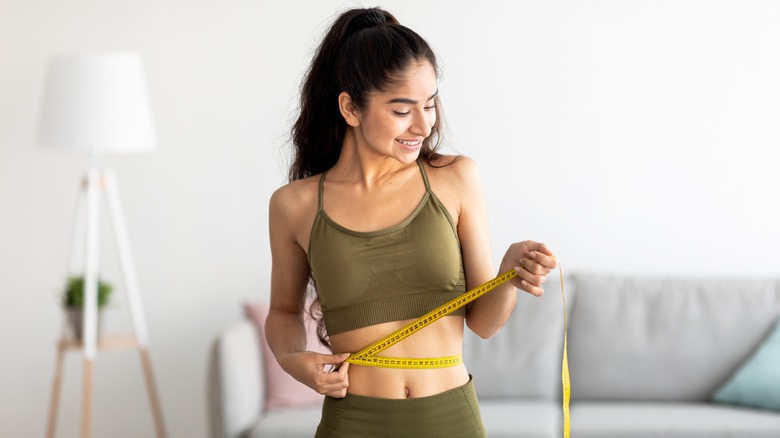 woman measuring waist