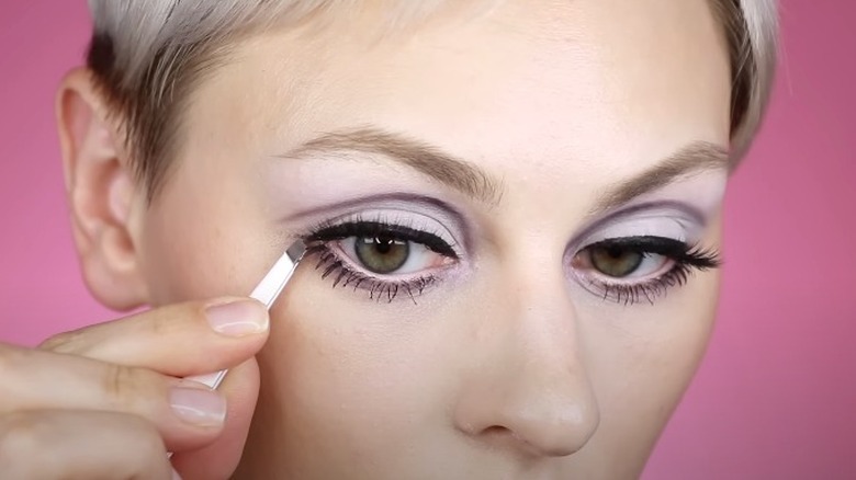 Alexandra Anele applying falsies