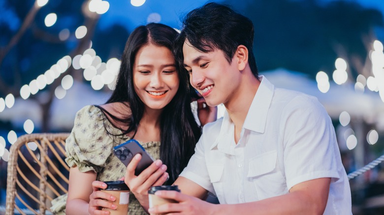 Couple looking at phones together