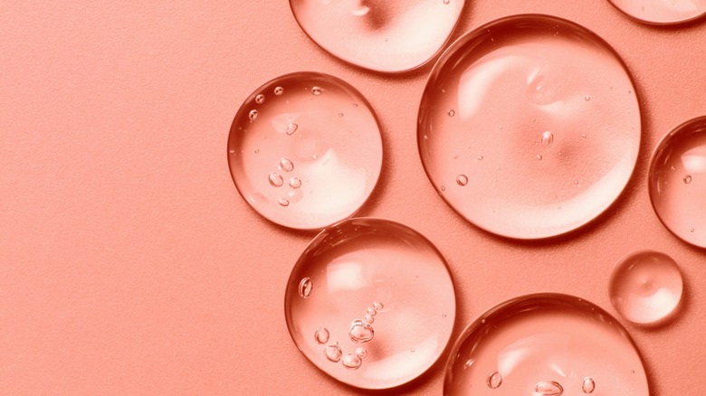 Gel droplets on a peach-colored background