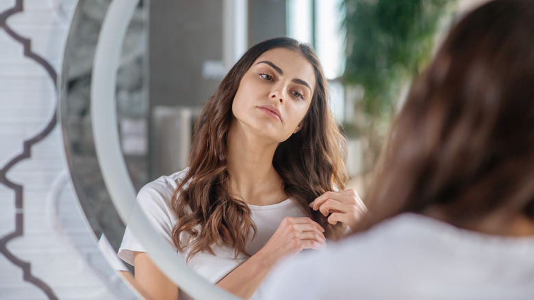 A woman looking in the mirror