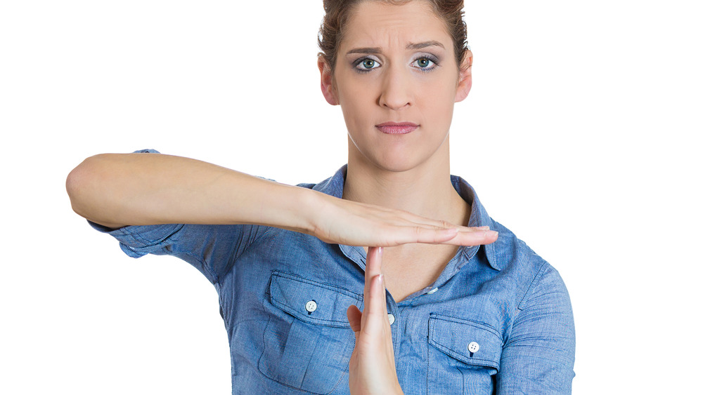 Woman making time-out gesture