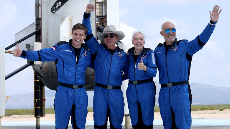 Jeff Bezos posing in front of his New Shepard rocket