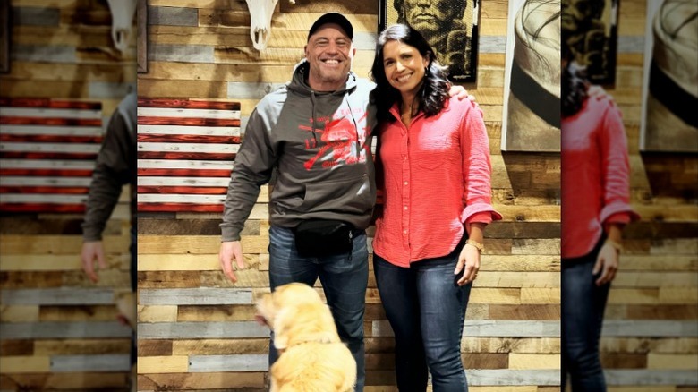 Joe Rogan and Tulsi Gabbard pose for a photo together in his studio