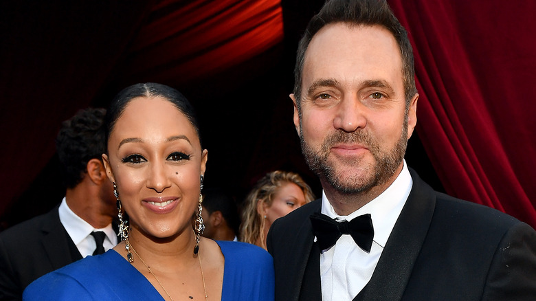 TV host Tamera Mowry and husband Adam Housley at an event 