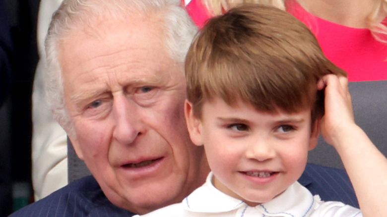 Prince Charles holding Prince Louis on his lap